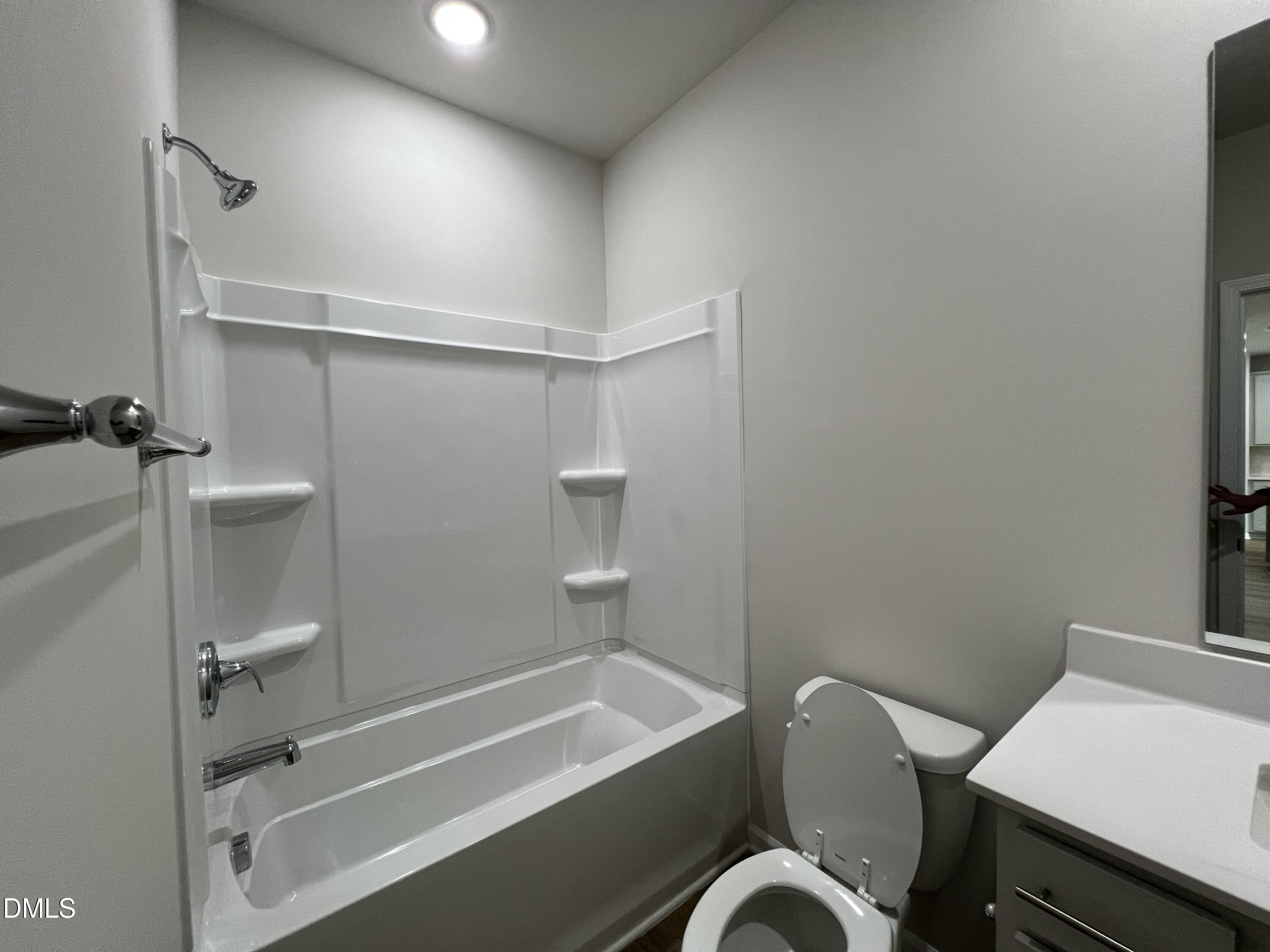 212 Thistle Patch Place Angier, NC 27501 - Photo 12 of 32 a bathroom with a sink a toilet and shower