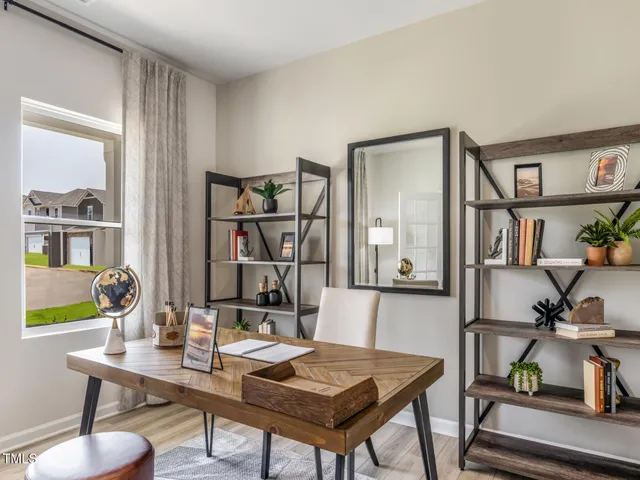 a kitchen with stainless steel appliances a sink a stove a refrigerator cabinets and a dining table