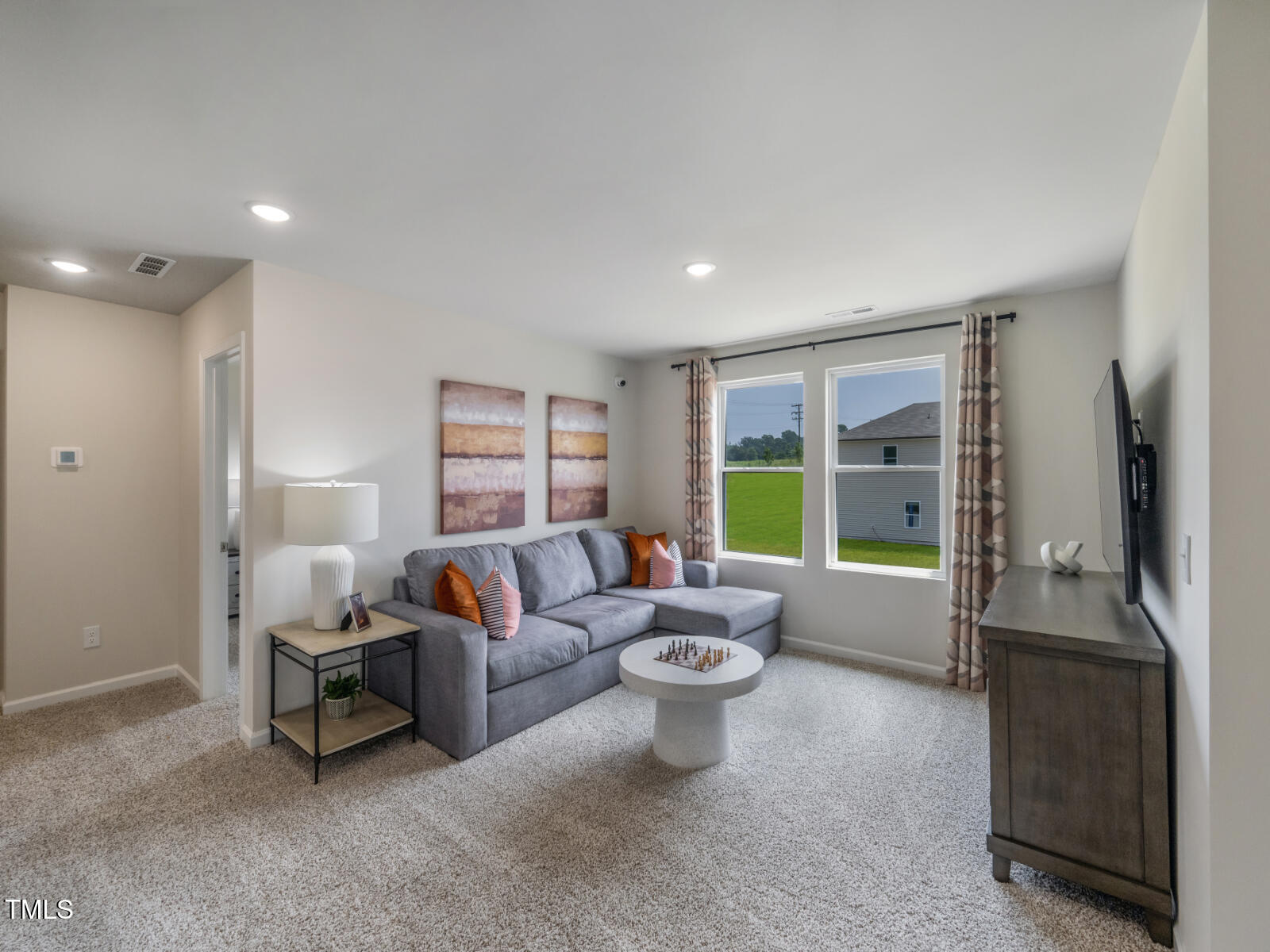 212 Thistle Patch Place Angier, NC 27501 - Photo 23 of 32 a living room with furniture and a large window