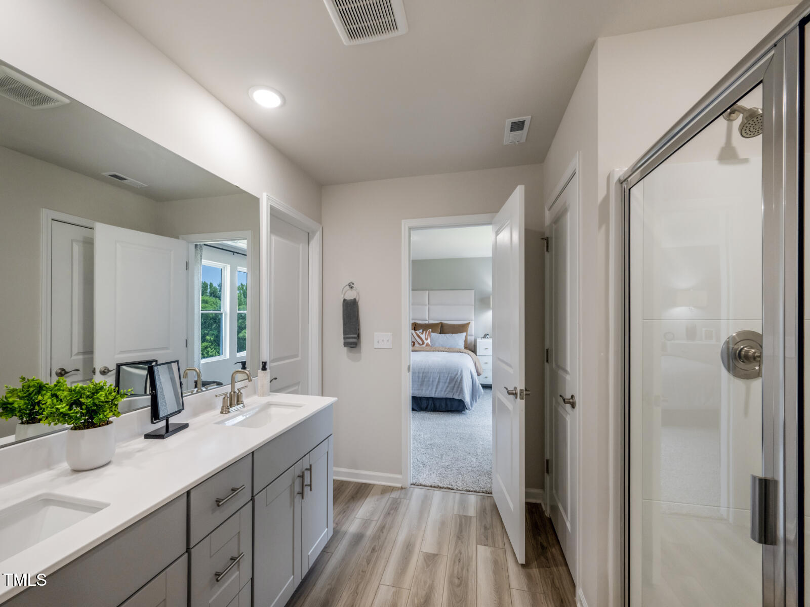 212 Thistle Patch Place Angier, NC 27501 - Photo 25 of 32 a en suite bathroom with a double vanity sink a mirror and shower