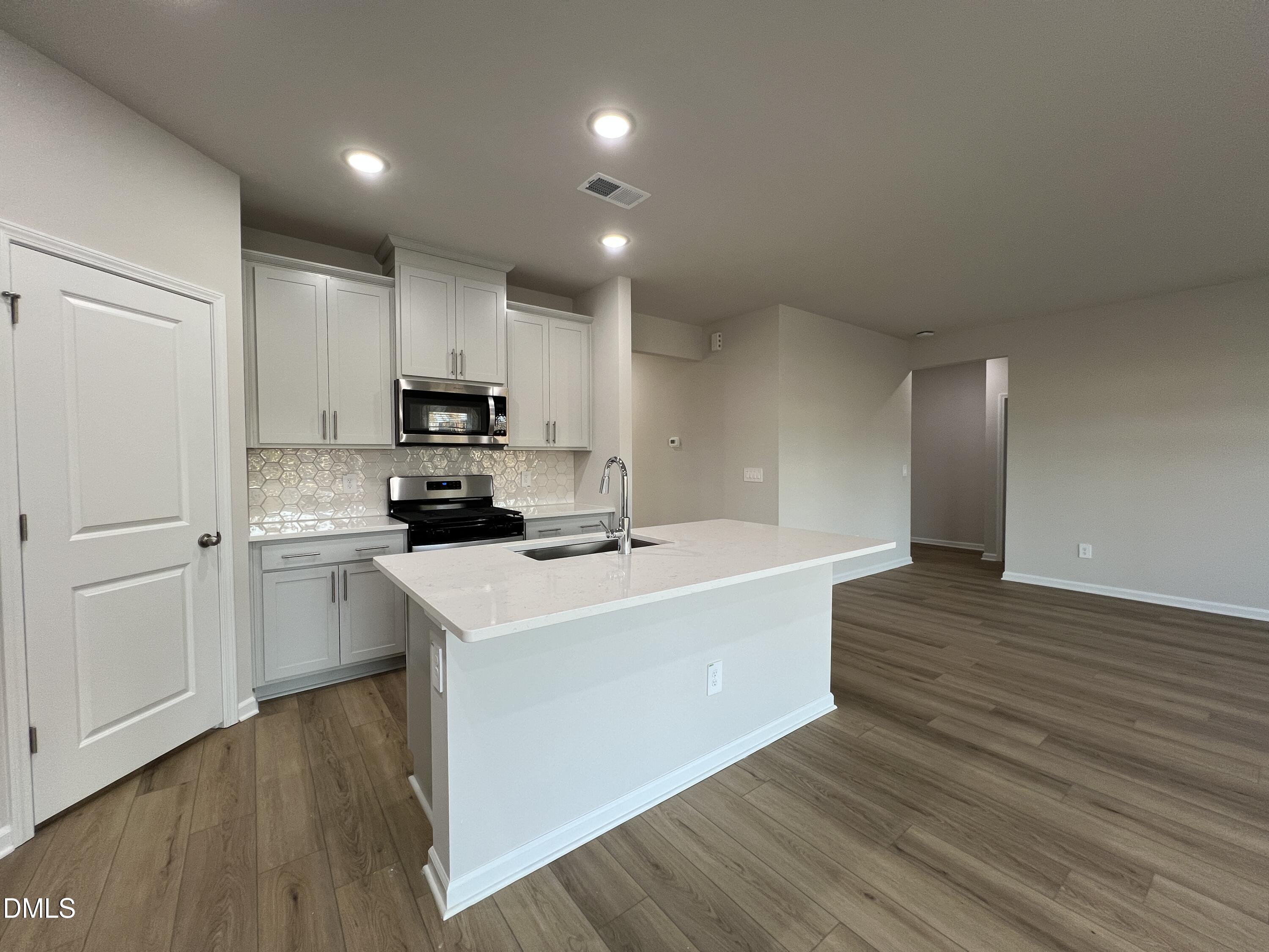 212 Thistle Patch Place Angier, NC 27501 - Photo 7 of 32 a view of kitchen with sink microwave and refrigerator