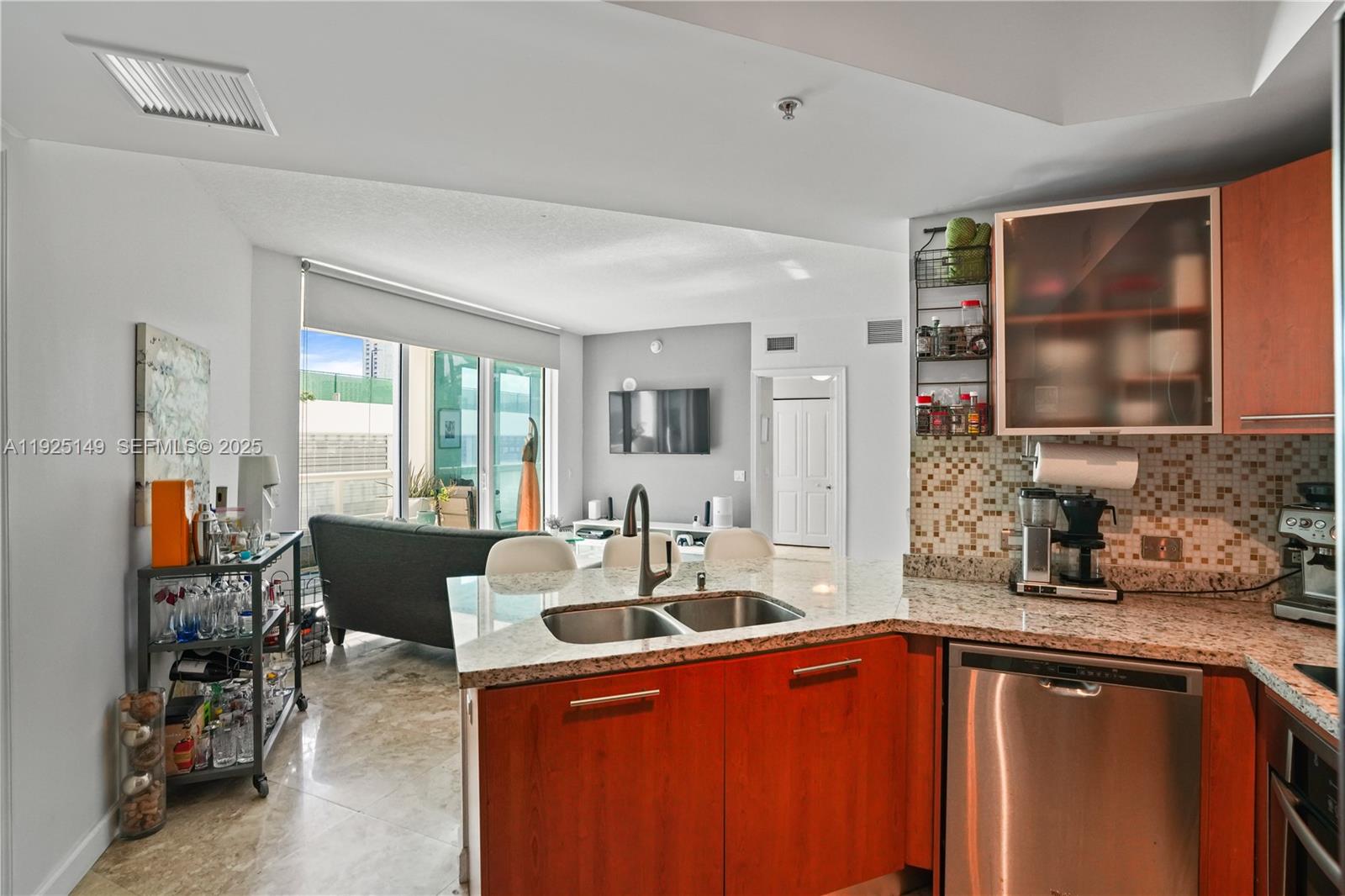 480 Northeast 30th Street, Unit 703 Miami, FL 33137 - Photo 11 of 31 a kitchen with stainless steel appliances granite countertop a sink stove and cabinets