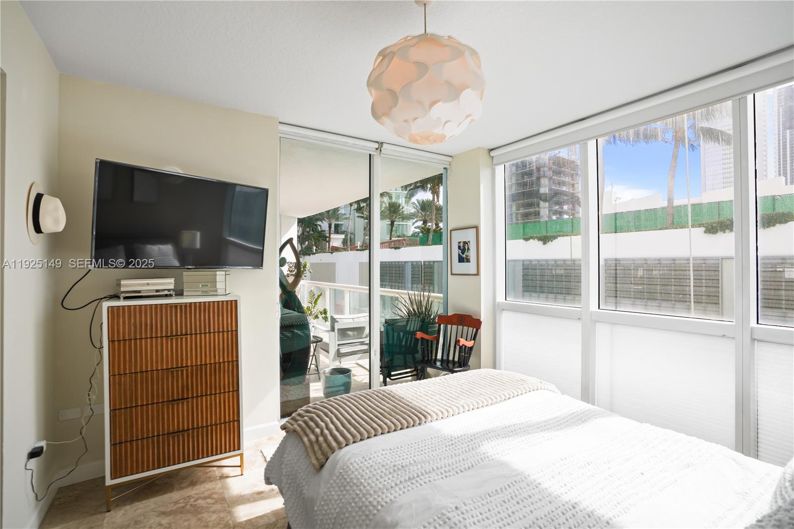 480 Northeast 30th Street, Unit 703 Miami, FL 33137 - Photo 15 of 31 a bedroom with a bed and a flat tv screen