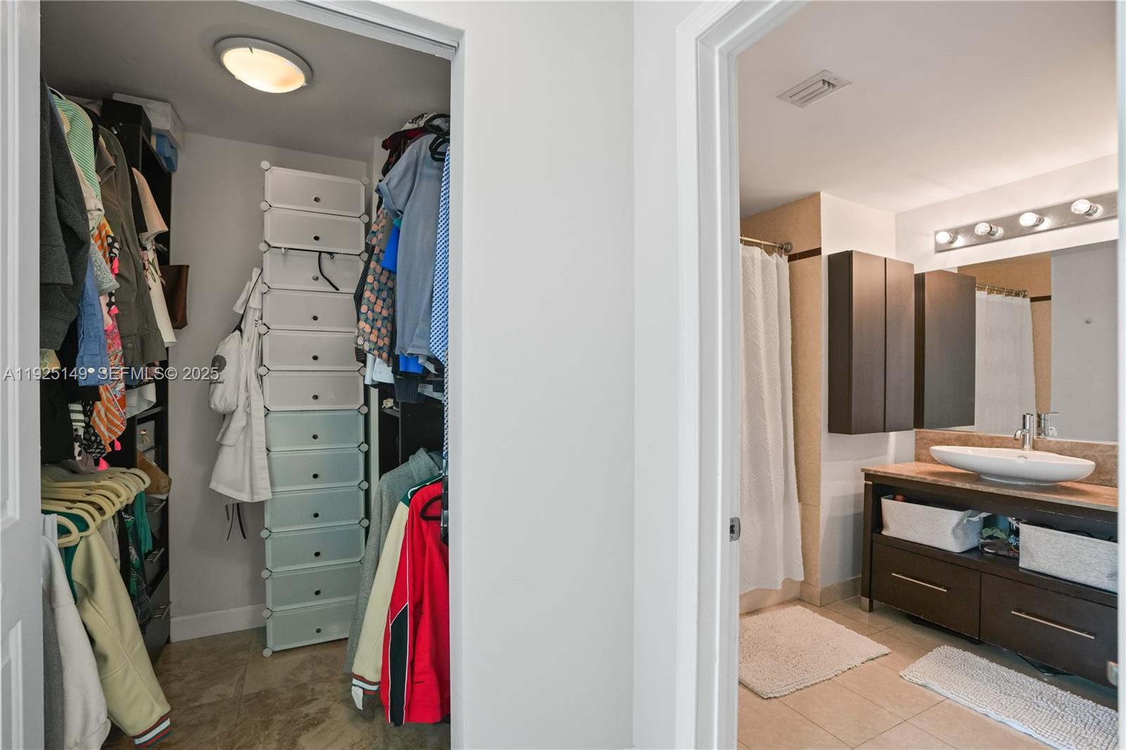480 Northeast 30th Street, Unit 703 Miami, FL 33137 - Photo 18 of 31 a view of walk in closet with clothes and shoes