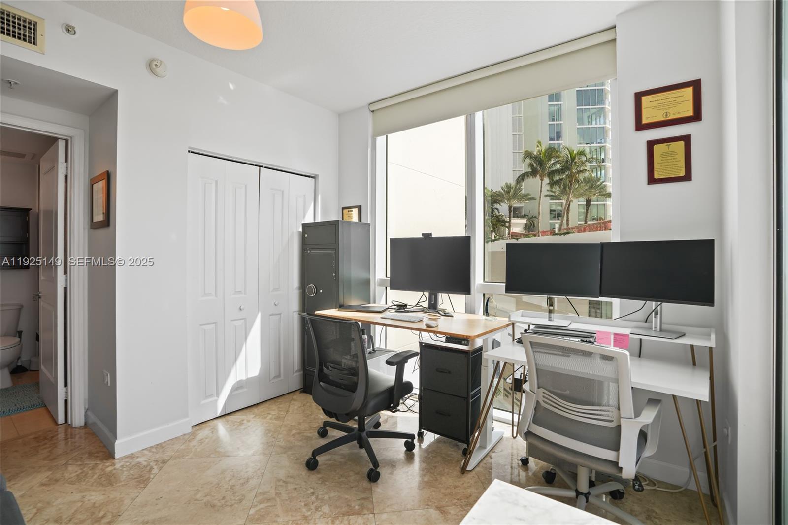 480 Northeast 30th Street, Unit 703 Miami, FL 33137 - Photo 19 of 31 a view of a workspace with furniture and a window