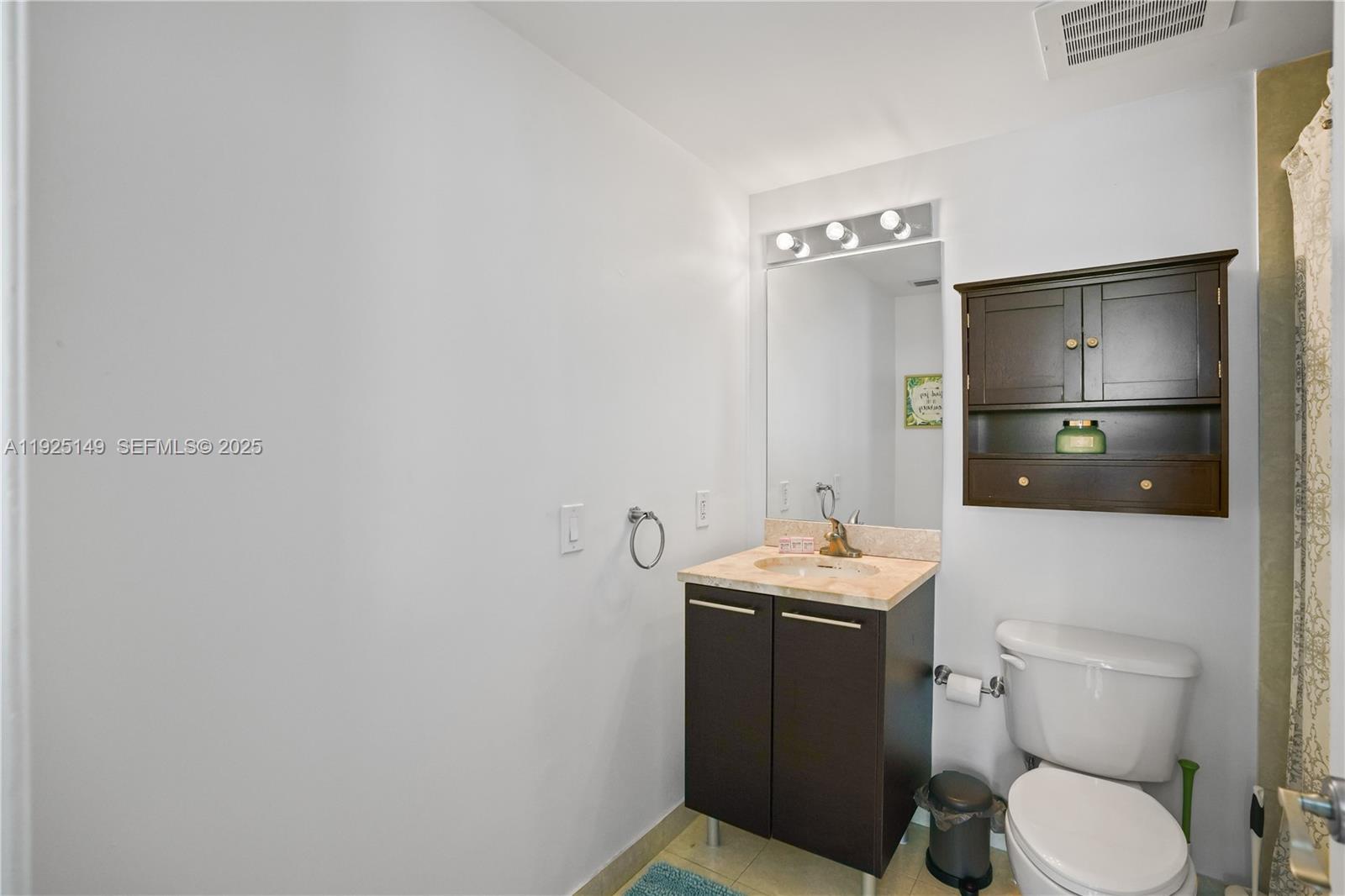 480 Northeast 30th Street, Unit 703 Miami, FL 33137 - Photo 22 of 31 a bathroom with a sink toilet and shower