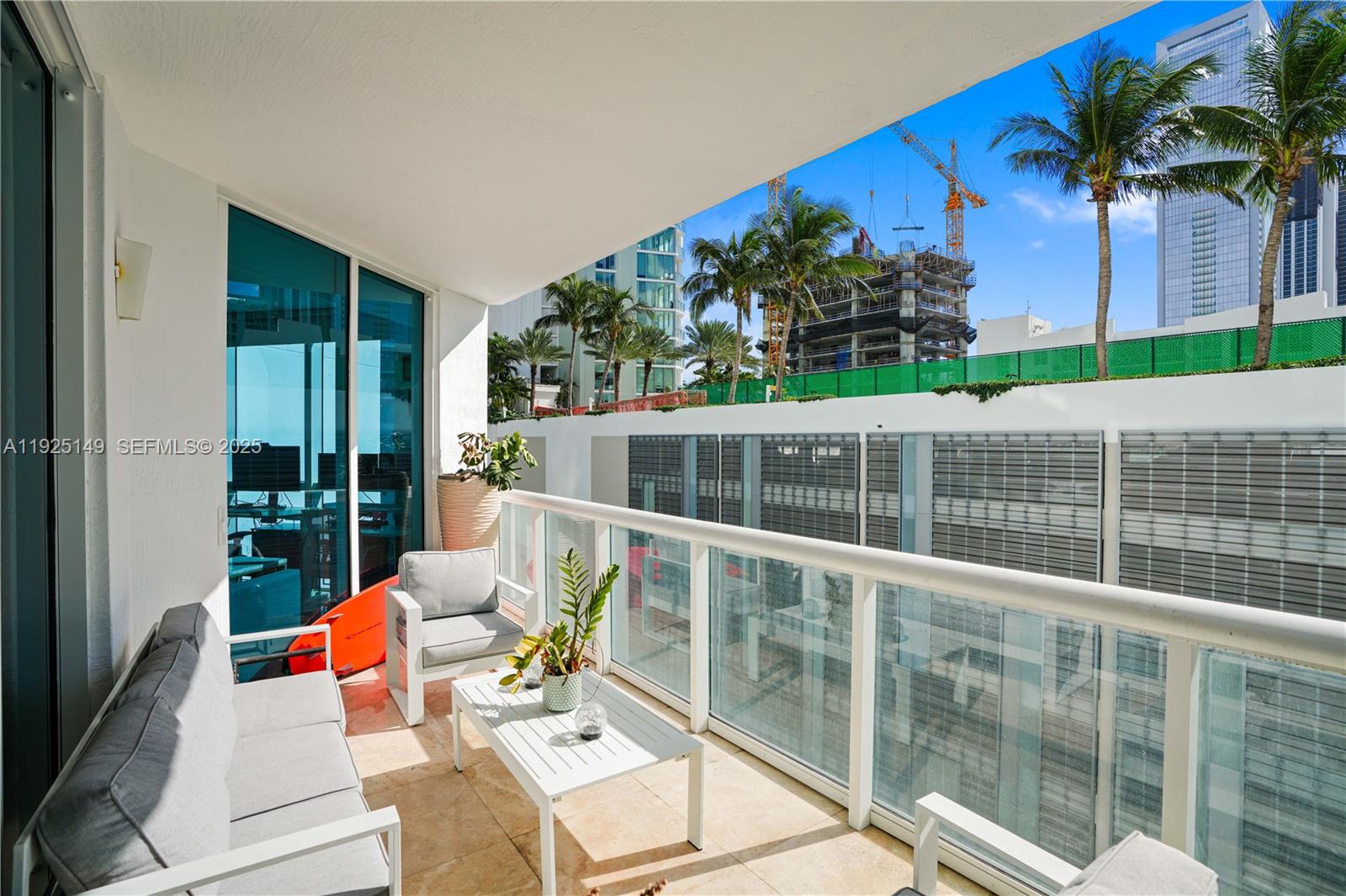 480 Northeast 30th Street, Unit 703 Miami, FL 33137 - Photo 25 of 31 a balcony with furniture and a potted plant