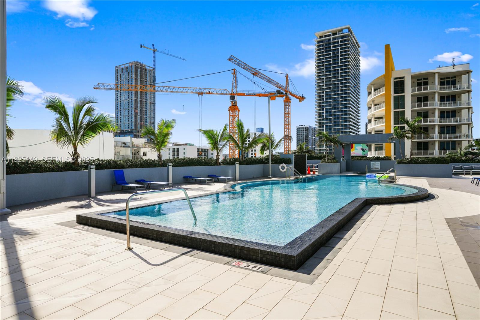 480 Northeast 30th Street, Unit 703 Miami, FL 33137 - Photo 27 of 31 a view of swimming pool with outdoor seating and buildings in the background