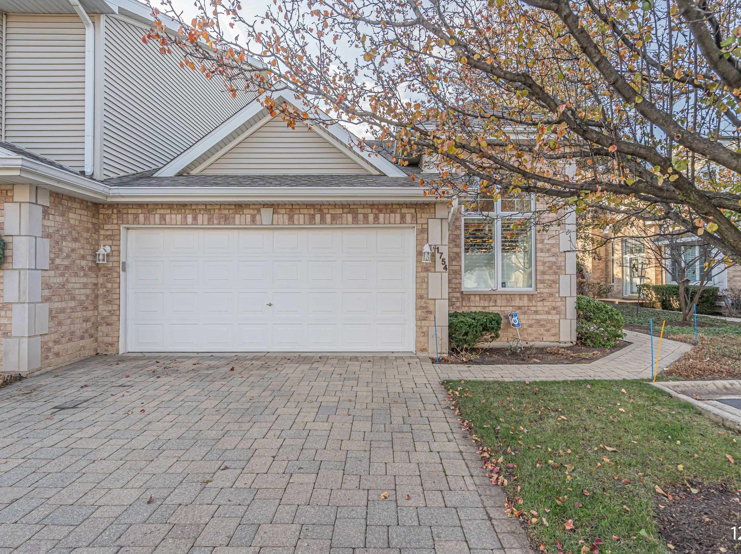 1754 Park Ridge Point, Unit 1754 Park Ridge, IL 60068 - Photo 37 of 39 a front view of a house with a yard and garage