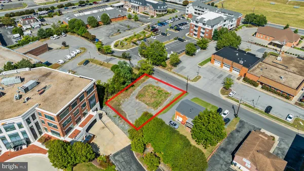 an aerial view of a residential apartment building with a yard