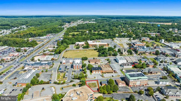 an aerial view of residential houses with outdoor space and street view