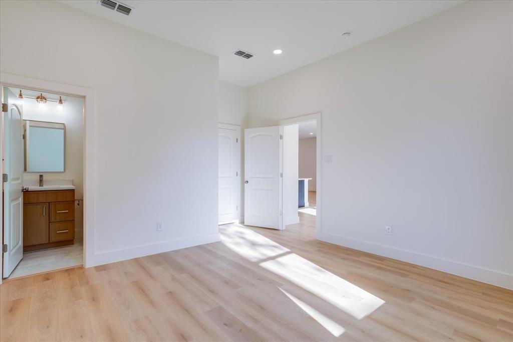 1507 Elk Creek Road Dallas, TX 75253 - Photo 29 of 40 a view of an empty room with window and wooden floor