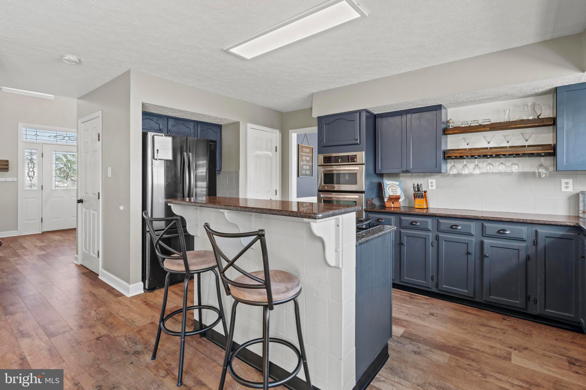181 Aberdeen Road Williamstown, NJ 08094 - Photo 8 of 29 a kitchen with stainless steel appliances granite countertop wooden cabinets a stove a sink and a refrigerator