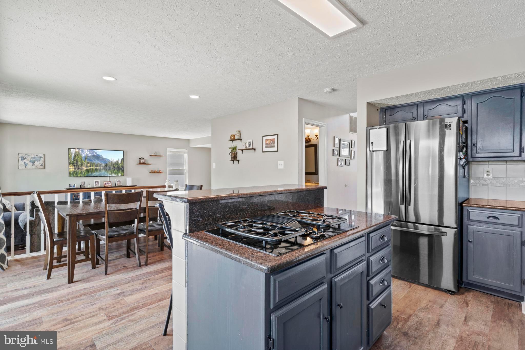 181 Aberdeen Road Williamstown, NJ 08094 - Photo 9 of 29 a kitchen with stainless steel appliances granite countertop a stove refrigerator and wooden floor