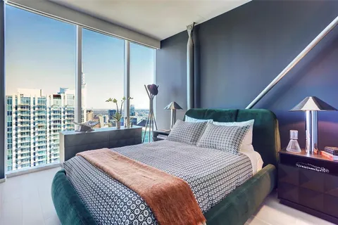 a bedroom with a large bed and a large window