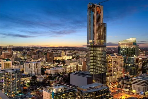 a large kitchen with kitchen island a large window a sink and stainless steel appliances