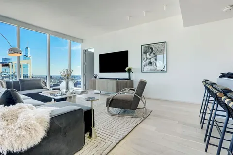 a living room with fireplace furniture and a flat screen tv