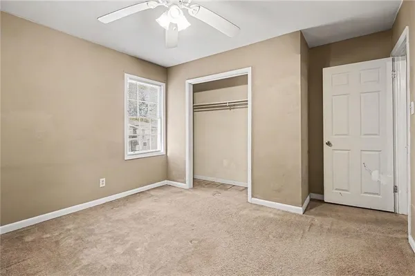 an empty room with windows and closet