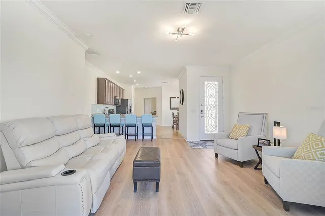 a living room with furniture and a chandelier