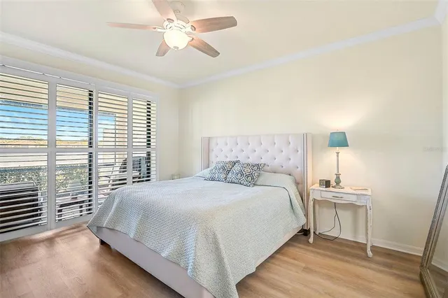 a bedroom with a bed a chandelier and a window