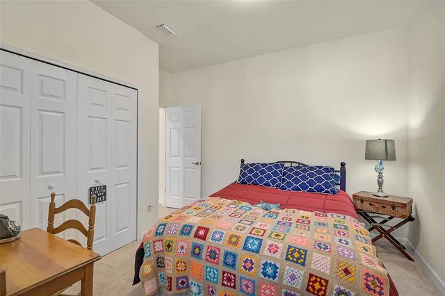 a bedroom with a bed and a dresser in it