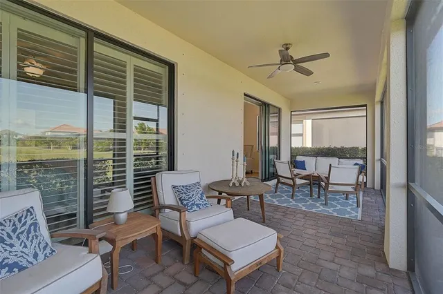 a living room with furniture a large window and a table