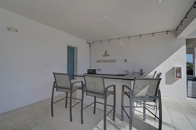 a view of a dining room with furniture and a kitchen