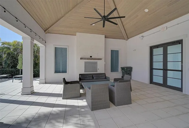 a living room with couches a dining table and with kitchen view