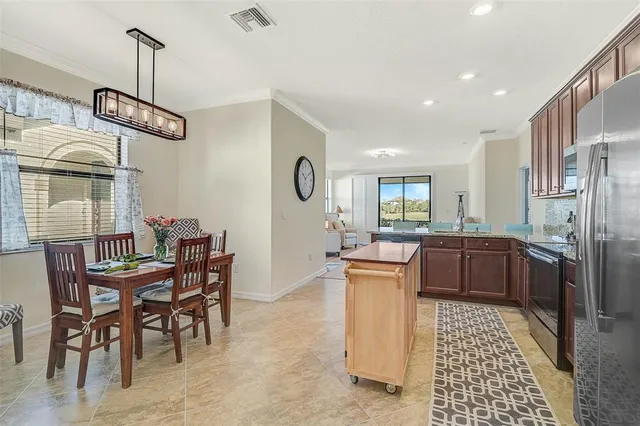 a kitchen with stainless steel appliances granite countertop a sink and a refrigerator