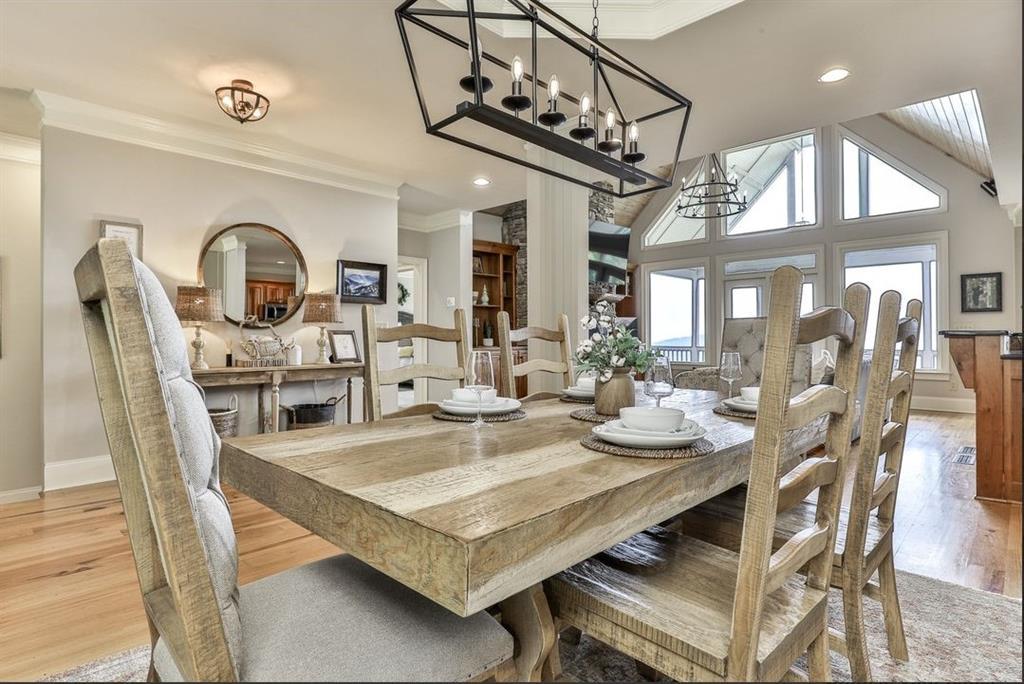 43 Toland Way Big Canoe, GA 30143 - Photo 11 of 50 a dining room with wooden floor a chandelier a wooden table and chairs