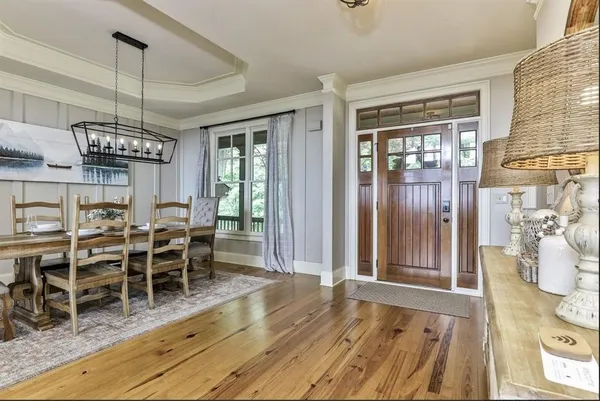 a view of a dining room with furniture window and wooden floor