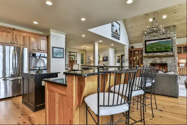 a view of a dining room kitchen with furniture and a fireplace