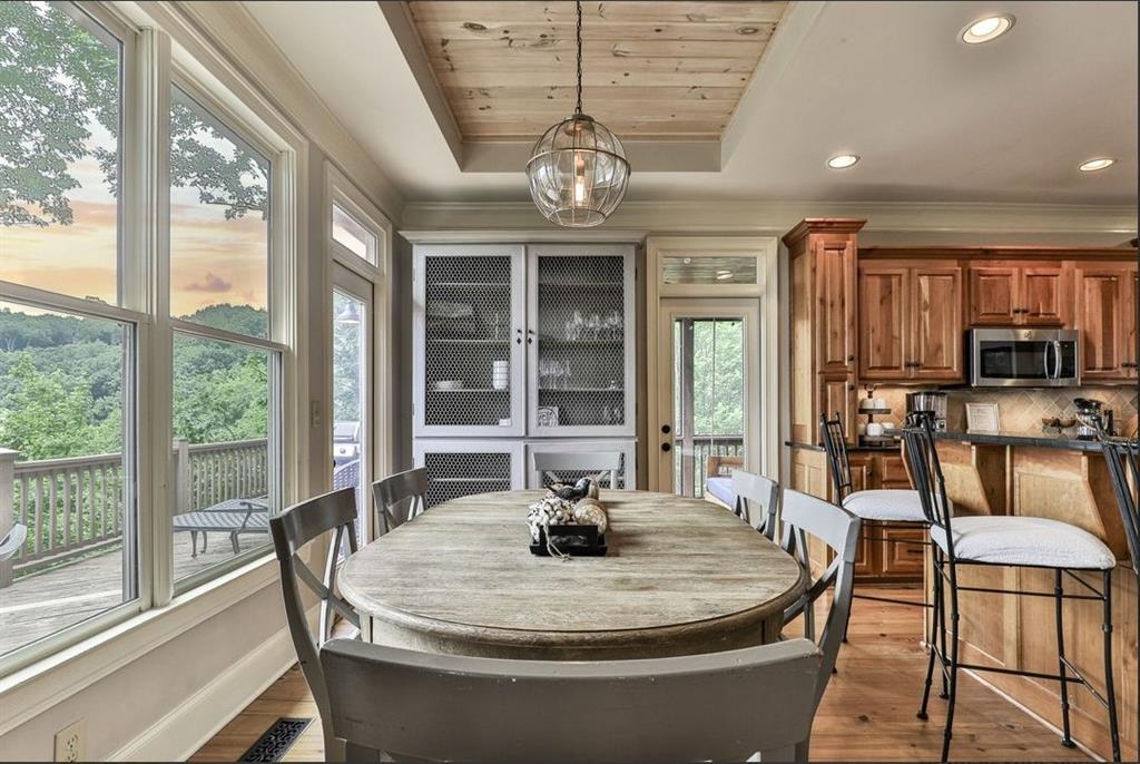 43 Toland Way Big Canoe, GA 30143 - Photo 17 of 50 a dining room with furniture a chandelier and wooden floor