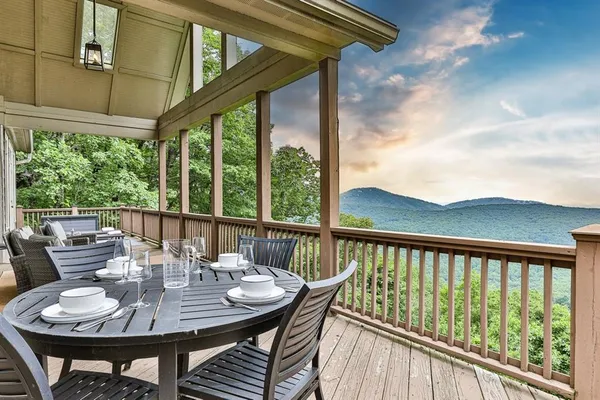 a view of a balcony with furniture and wooden floor