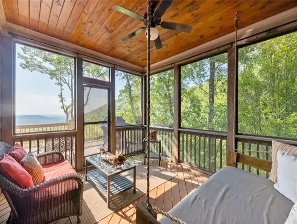 a balcony with furniture and a potted plant