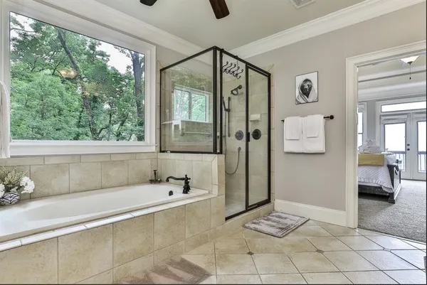 a bathroom with a bathtub and a shower