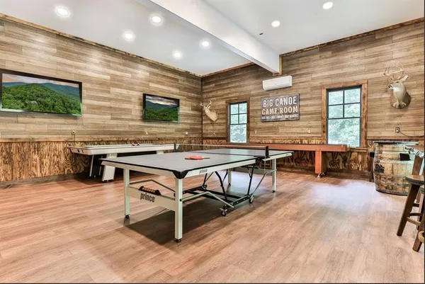 a living room with stainless steel appliances kitchen island granite countertop furniture and a wooden floor