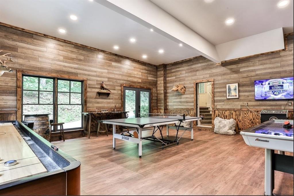 43 Toland Way Big Canoe, GA 30143 - Photo 32 of 50 a living room with furniture a flat screen tv and a large window
