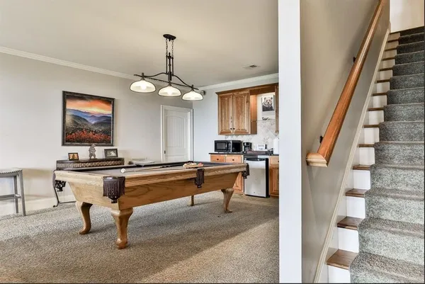 a living room with furniture a rug and white walls