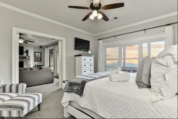 a bedroom with furniture and a large window