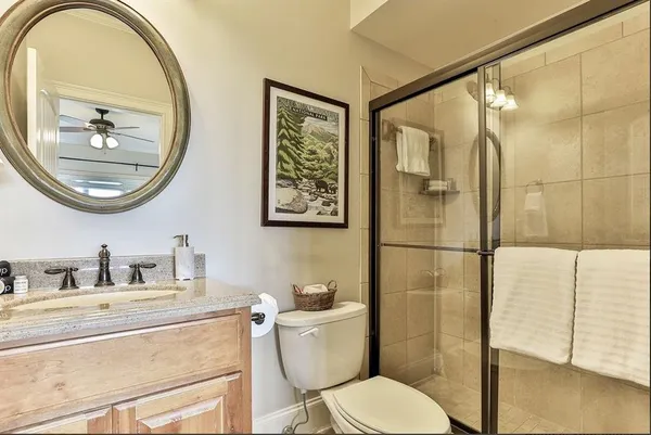 a bathroom with a toilet a sink and a mirror