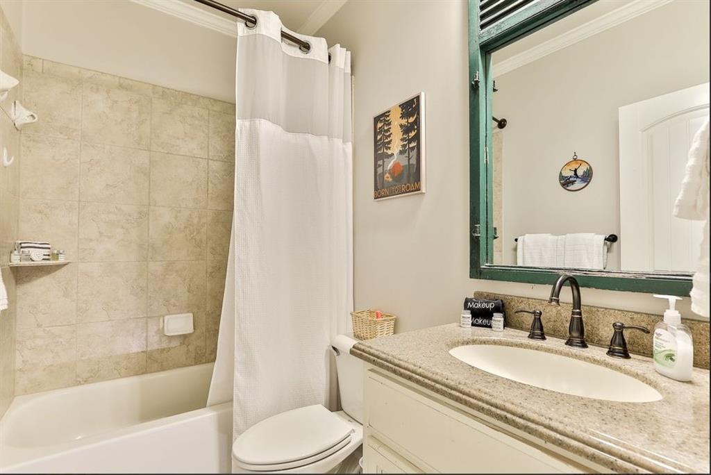 43 Toland Way Big Canoe, GA 30143 - Photo 44 of 50 a bathroom with a granite countertop toilet sink and a mirror