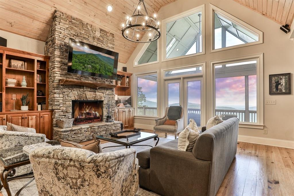 43 Toland Way Big Canoe, GA 30143 - Photo 8 of 50 a living room with furniture a fireplace and a chandelier