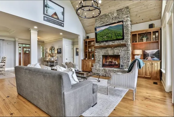a living room with furniture a flat screen tv and a fireplace