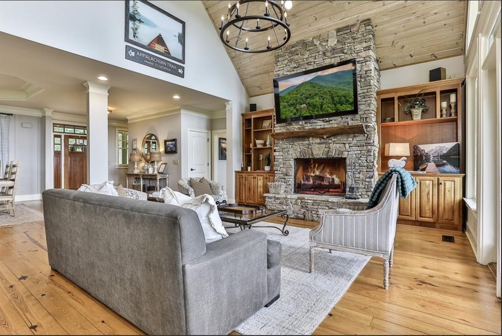 43 Toland Way Big Canoe, GA 30143 - Photo 10 of 50 a living room with furniture a flat screen tv and a fireplace