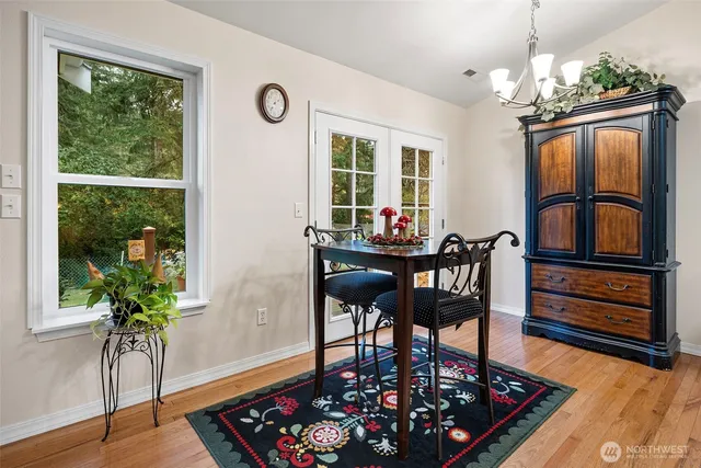 a view of a dining room with furniture window and wooden floor