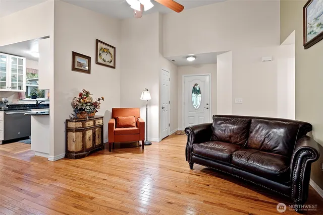 a living room with furniture and wooden floor