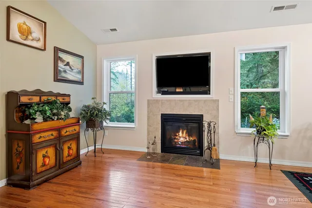 a living room with furniture a flat screen tv and a fireplace