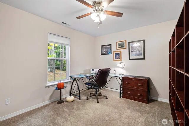 a view of workspace with furniture and windows