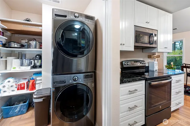 a kitchen with stainless steel appliances a stove top oven and cabinets